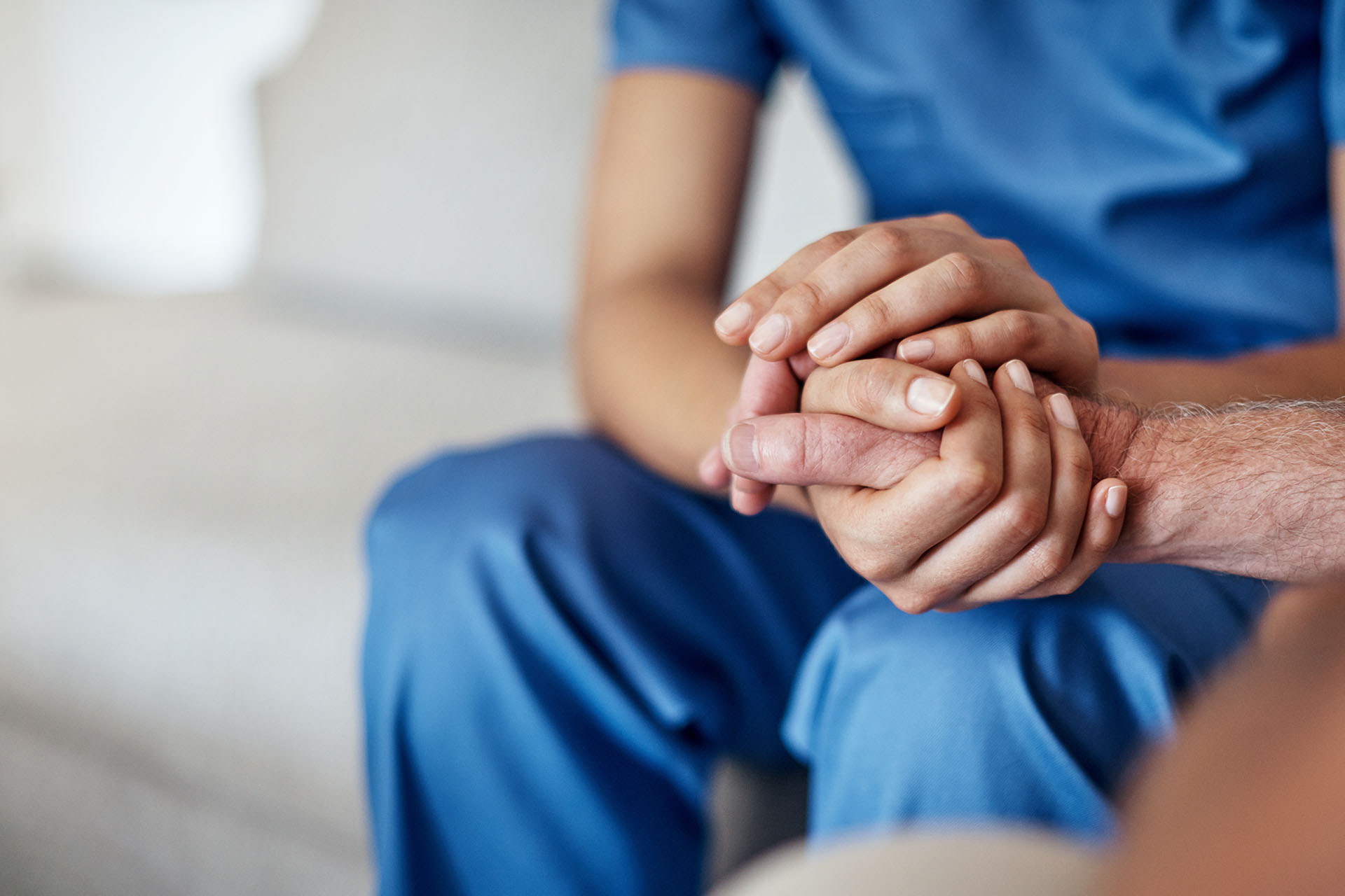 Cropped shot of a female carer consoling a senior patient at the nursing home